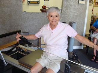 older woman doing pilates image