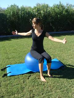 pilates spine twist on exercise ball