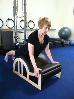 Exercise for winged scapula on the arc barrel.