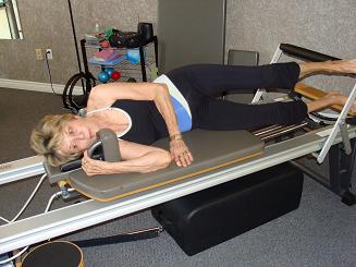 side lying exercise on pilates reformer imag